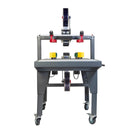 Máquina semiautomática precintadora de cajas con tracción lateral